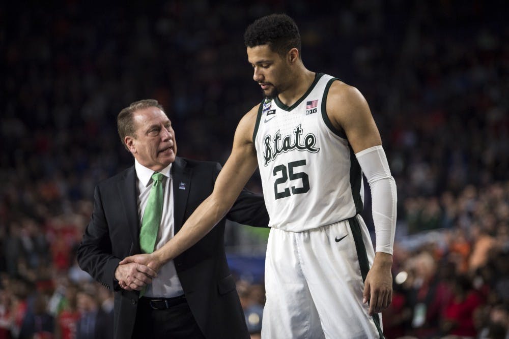 Michigan State head coach Tom Izzo comforts Senior forward Kenny Goins (25) in the last minutes of the second half of the NCAA Final Four game against Texas Tech at U.S. Bank Stadium in Minneapolis on April 6, 2019. The Spartans lost to the Red Raiders 61-51.  (Nic Antaya/The State News)