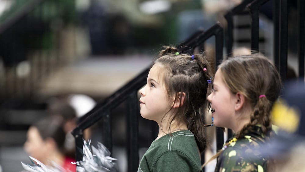 Young Spartan fans cheer from the stands during the volleyball match against USC at the Breslin Center on Wednesday, Nov. 26, 2025.