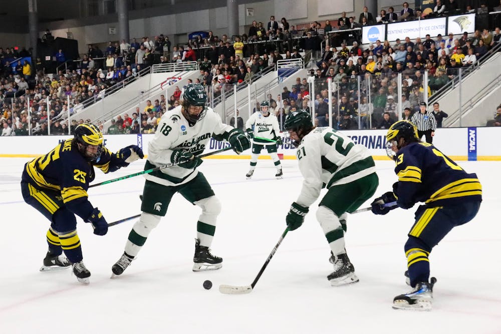 <p>Sophomore forward No. 18 Joey Larson and junior forward No. 21 Red Savage keep the puck in play in the NCAA Regional game against the University of Michigan at Centene Ice Center on March 31, 2024.</p>