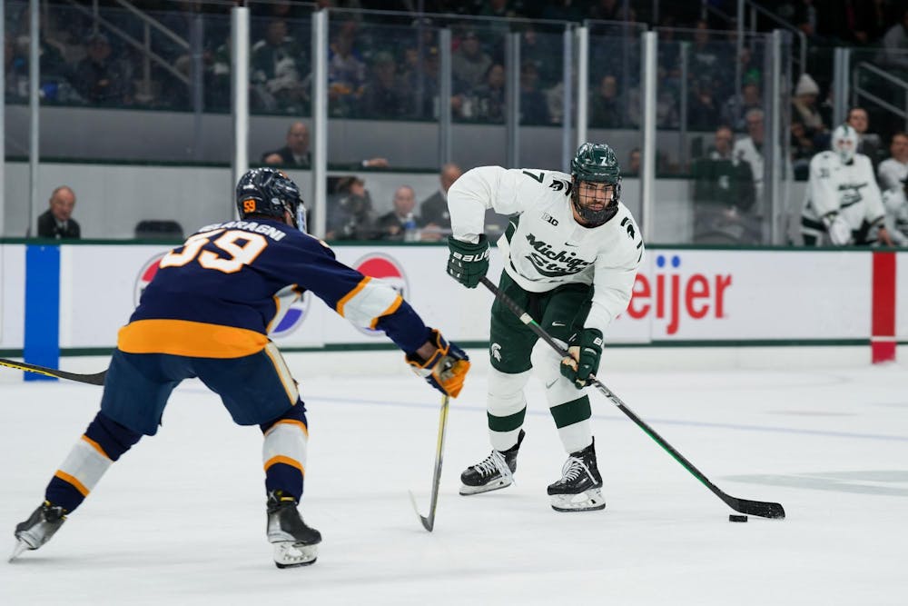 <p>Junior defender David Gucciardi (7) with the puck during a game against Canisius at Munn Ice Arena on Oct. 19, 2023. The Spartans beat the Griffins 6-3 in one of a two-game series.</p>