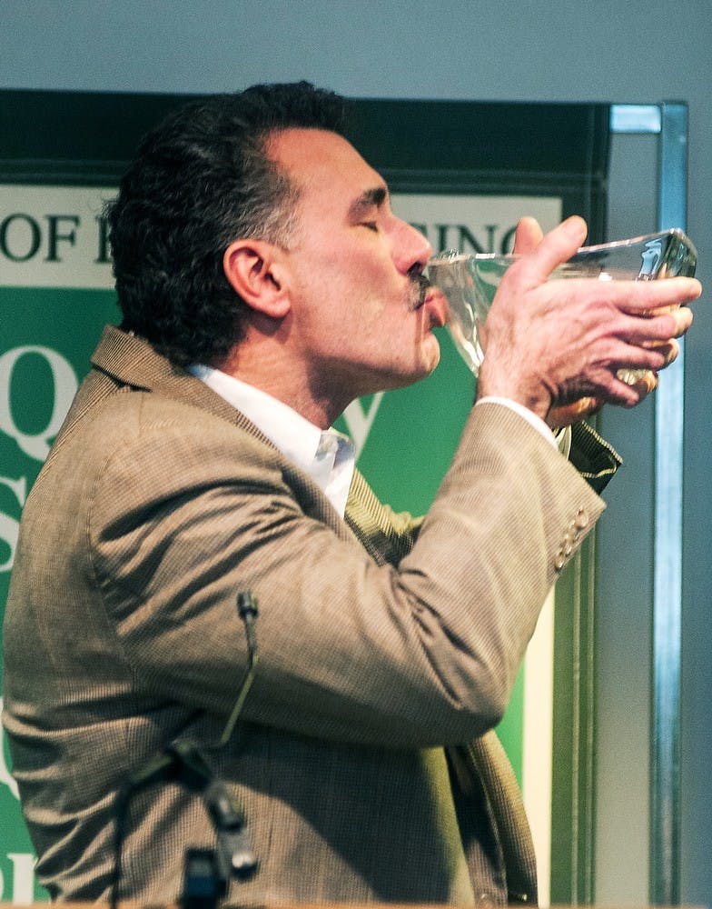 	<p>East Lansing resident and one of the four Crystal Award winners Tom Petroni kisses the award before giving his acceptance speech, April 25, 2013, at the Hannah Community Center. The awards were given to community members who demonstrated outstanding service. Danyelle Morrow/The State News</p>