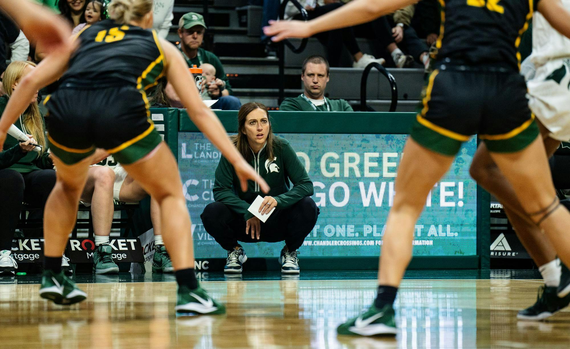 <p>Michigan State University women's basketball head coach Robyn Fralick watches intently during the season-opening exhibition game against Wayne State University at the Breslin Center on Oct. 28, 2024. The Spartans beat the Warriors, 101-40.</p>