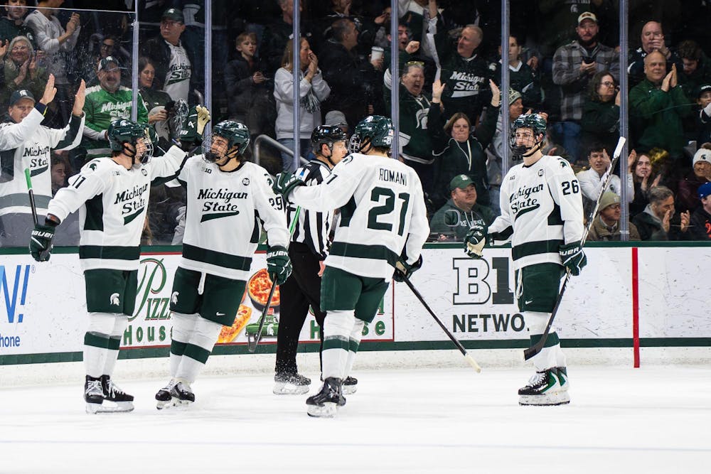 Michigan State hockey teammates celebrate with each other after scoring a point against University of Notre Dame at Munn Ice Arena in East Lansing, Michigan, on Friday, Feb. 20, 2026.