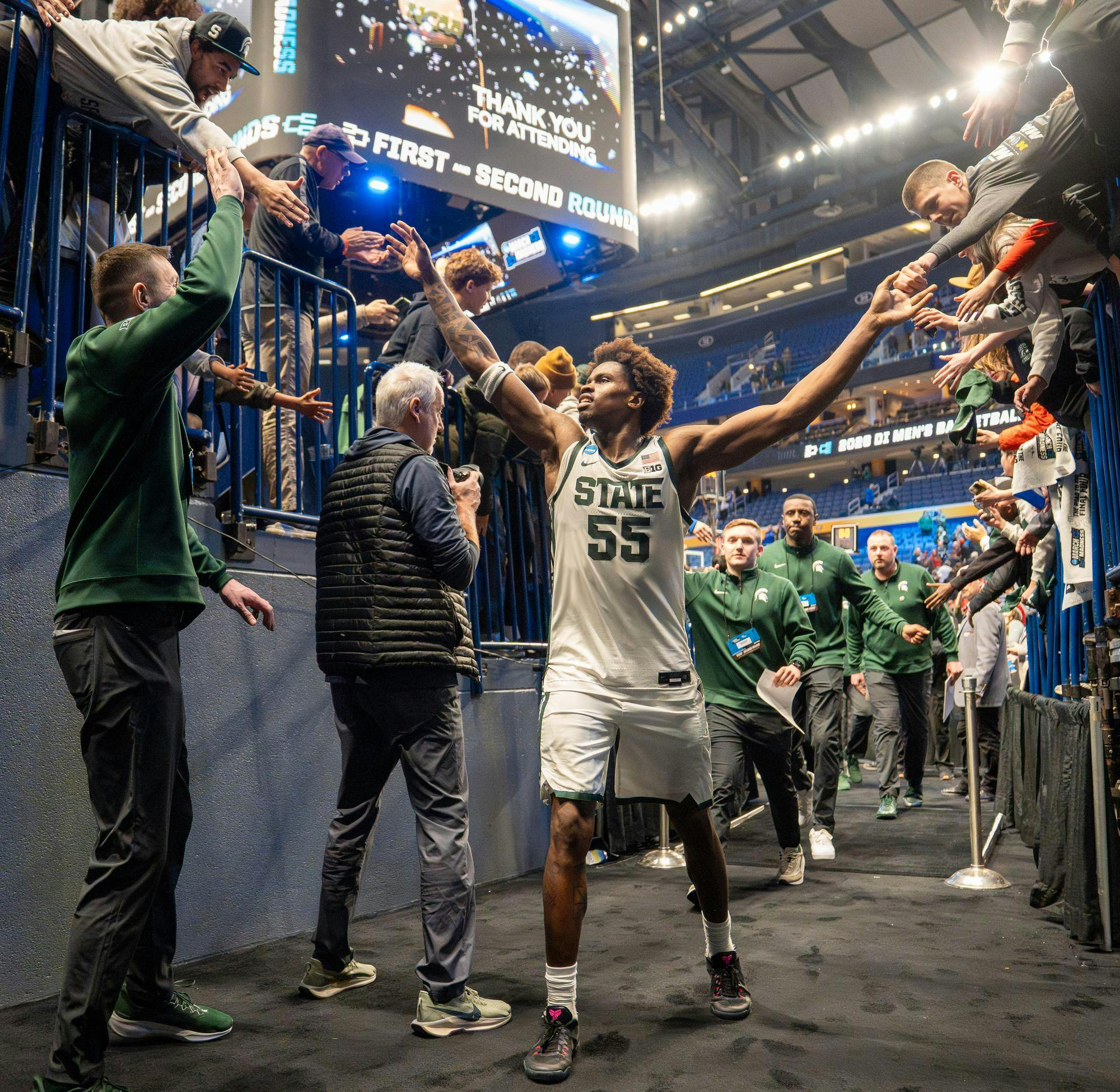 Junior forward Coen Carr (55) high-fives fans as he exits the tunnel after their 2nd round March Madness win against University of Louisville at the KeyBank Center in Buffalo, New York on March 21, 2026.