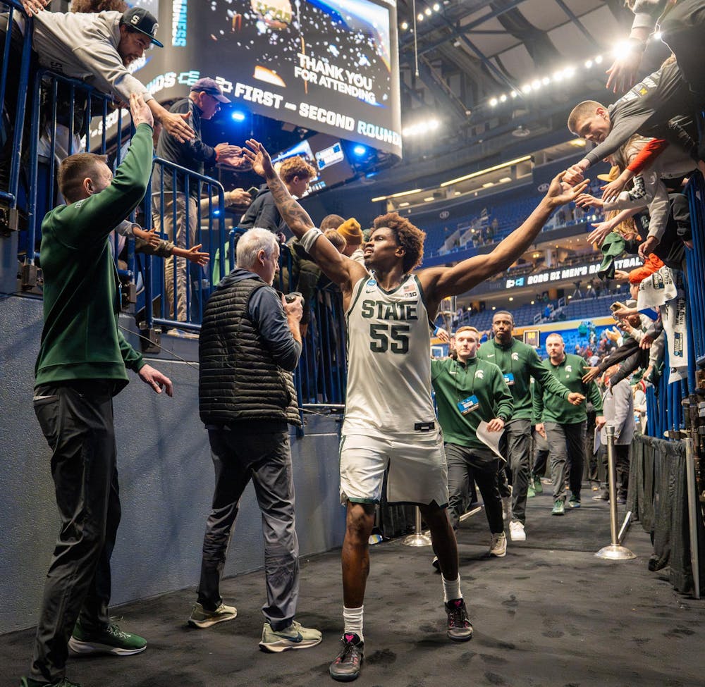 <p>Junior forward Coen Carr (55) high-fives fans as he exits the tunnel after their second round March Madness win against University of Louisville at the KeyBank Center in Buffalo, New York on March 21, 2026.</p>