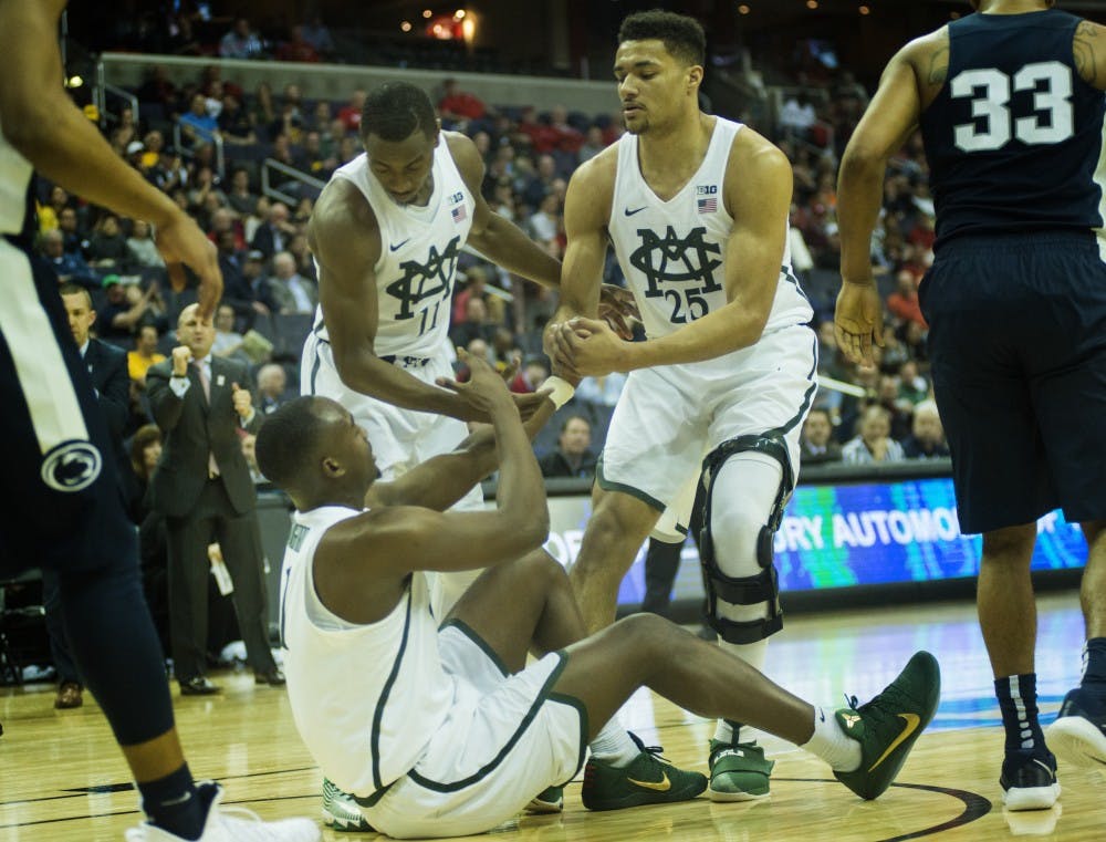 Junior guard Lourawls 'Tum Tum' Nairn Jr. (11) and red-shirt sophomore guard Kenny Goins (25) help freshman guard Joshua Langford (1) in the first half of the game against Penn State during the second round of the Big Ten Tournament on March 9, 2017 at Verizon Center in Washington D.C. The Spartans defeated the Nittany Lions, 78-51.