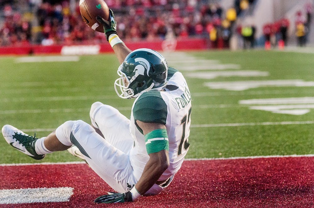 Junior wide receiver Bennie Fowler catches the winning touchdown in the endzone Saturday, Oct. 27, 2012, at Camp Randall Stadium in Madison, WI. The Spartans defeated the Wisconsin Badgers 16-13 with a pass from junior quarterback Andrew Maxwell to Fowler during overtime. Adam Toolin/The State News