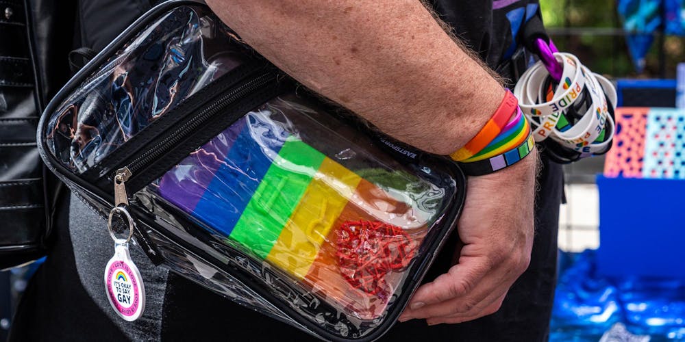 <p>An East Lansing Pride attendee collects many pride accessories as they walk along Albert Ave in East Lansing, Mich., on June 13, 2026.</p>