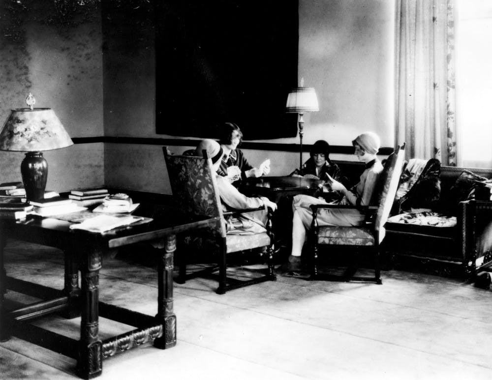 <p>Students from the the university, which then was known as Michigan State College of Agriculture and Applied Science, play a card game in a lounge in Mayo Hall in the 1930s. Mary Mayo, the hall's namesake, is rumored to haunt this building.</p>