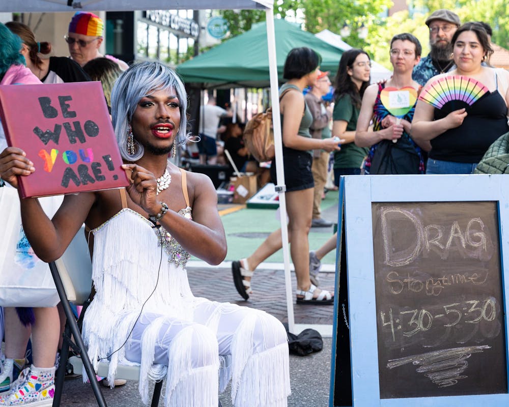<p>Drag performer Auroara Manifesto reads a self-made book during East Lansing Pride on Albert Ave in East Lansing, Mich., on June 13, 2026.</p>