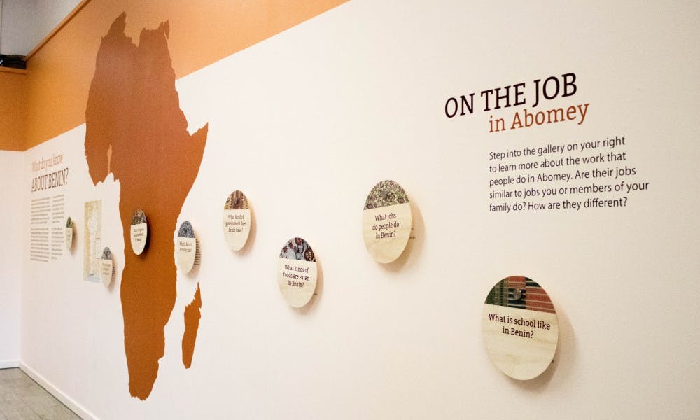 The entrance wall to the Abomey exhibit is pictured in the MSU Museum on Aug. 29, 2018. The exhibit asks visitors to notice the differences and similarities between the professions in Abomey and those in their own families.