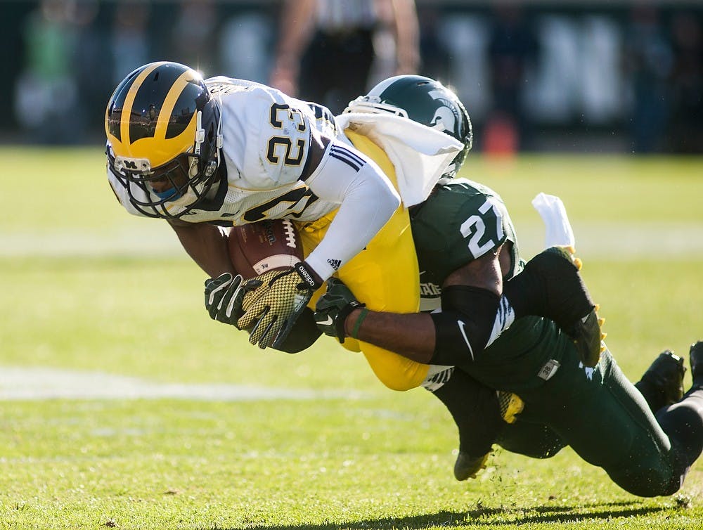 <p>Senior safety Kurtis Drummond tackles Michigan wide receiver Dennis Norflee during the game on Oct. 25, 2014, at Spartan Stadium. The Spartans defeated the Wolverines, 35-11. Aerika Williams/The State News</p>