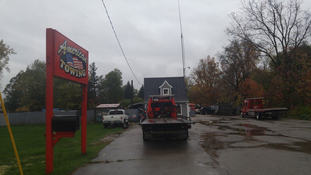 <p>The storefront of American Towing, where at least one bus from LansingParty.com, LLC, is stored after they were impounded by the Clinton County Sheriff Oct. 14, 2017.</p>
