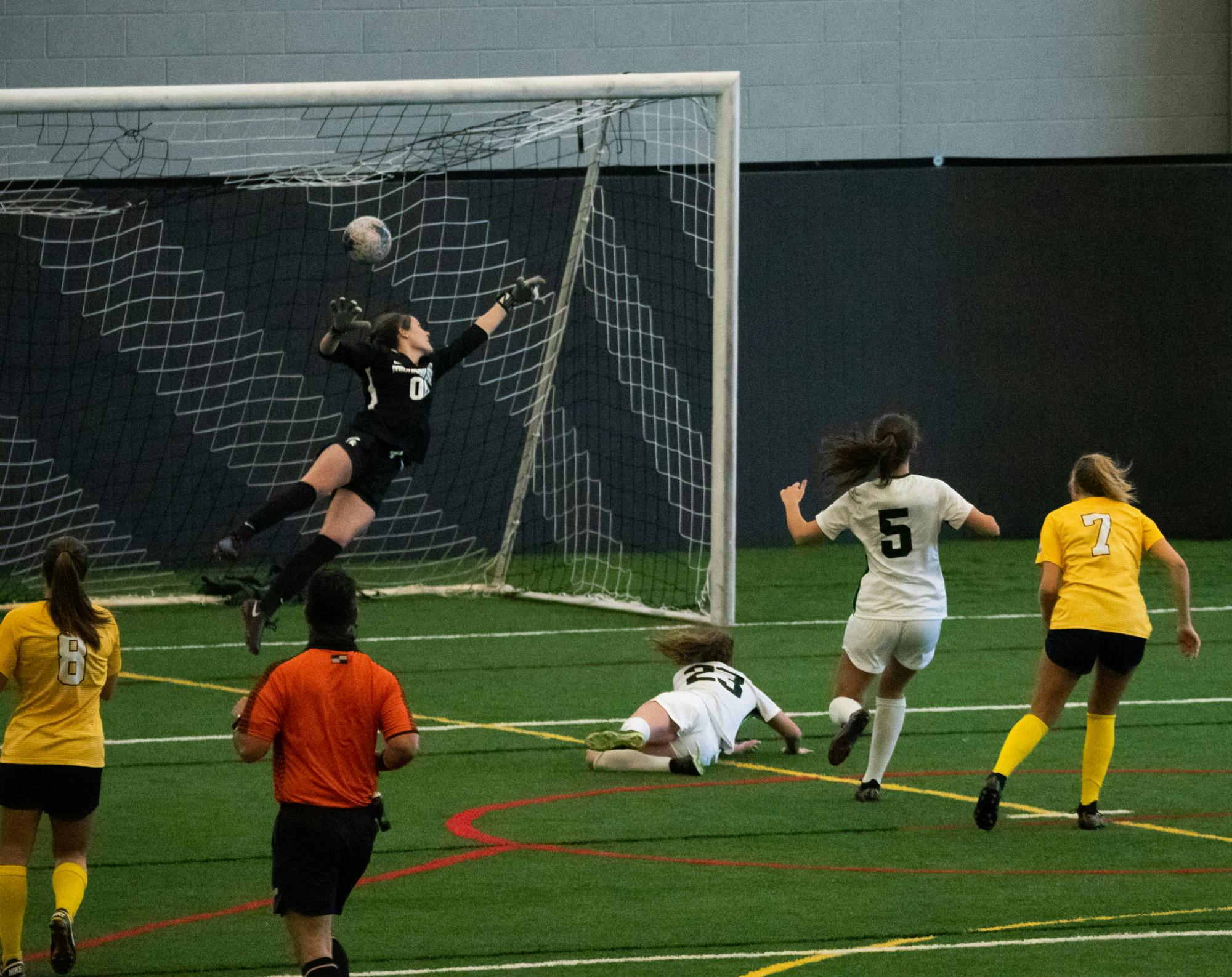 <p>University of Michigan&#x27;s Meredith Haakenson (7) scores a goal against the Spartans on March 12, 2021.</p>