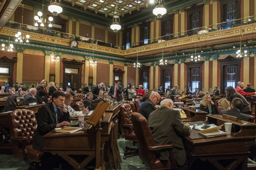 State Representatives gather and get ready to go over newly appointed bills on Feb. 22, 2018 at Michigan State Capitol Building. (C.J. Weiss | The State News)
