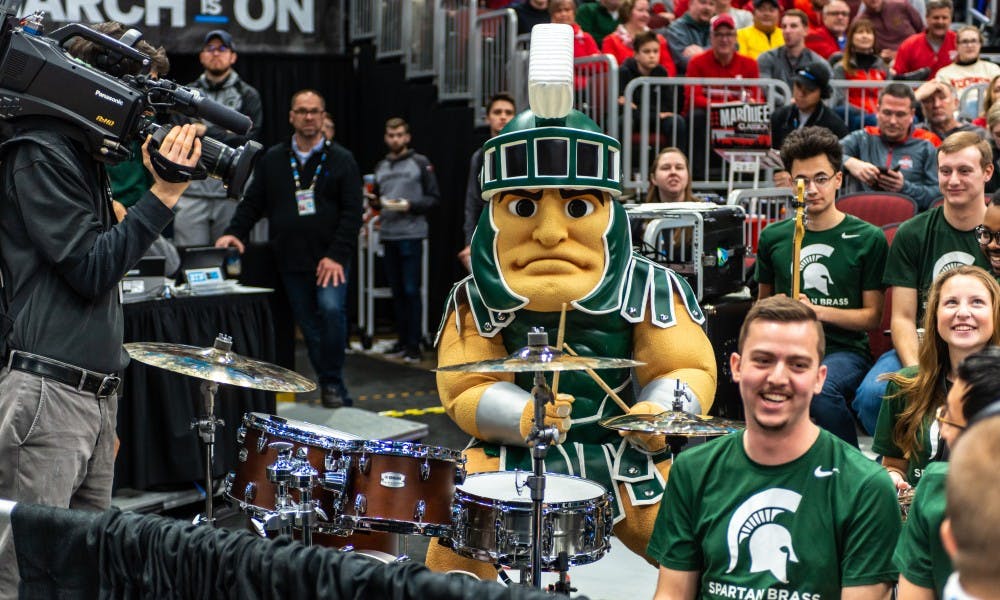 <p>Sparty joins the Spartan Brass during a timeout vs. Ohio State. The Spartans beat the Buckeyes, 77-70 at the United Center on March 15, 2019.</p>
