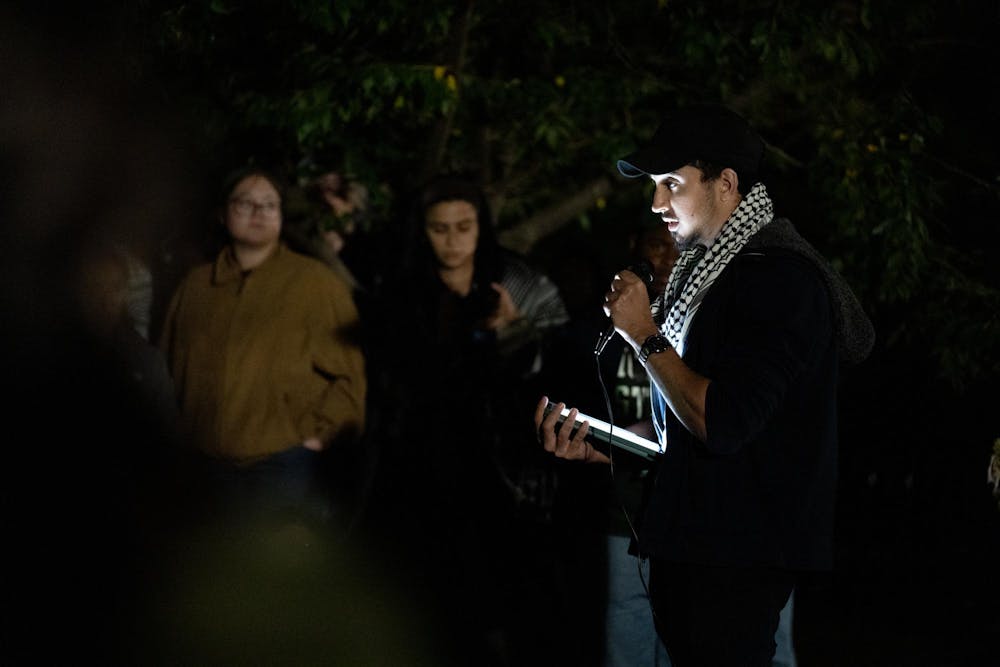 A Michigan State University student with the MSU Students for Justice in Palestine organization speaks outside Beaumont Tower, Oct. 7, 2024. The MSU Students for Palestine held a night of remembrance for those who have lost their lives in Gaza after conflict in the region escelated, following attacks in Israel one year ago. 
