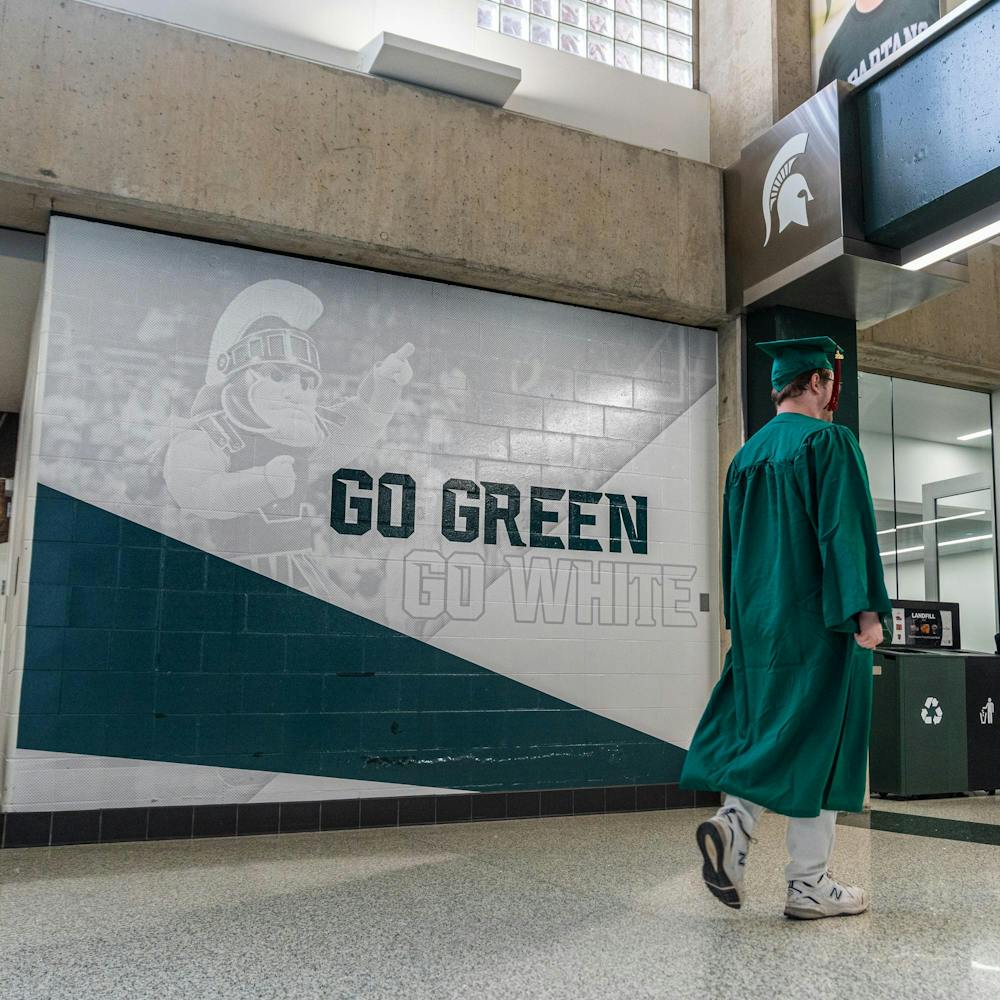 <p>A graduating Michigan State student walks around the Breslin Center concourse before a convocation in East Lansing, Mich., on May 1, 2026.</p>