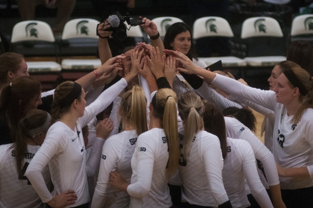 The volleyball team puts their hands together during the volleyball game against Notre Dame on Sept. 16, 2016 at the Jenison Field House. The Spartans defeated the Fighting Irish, 3-0. 