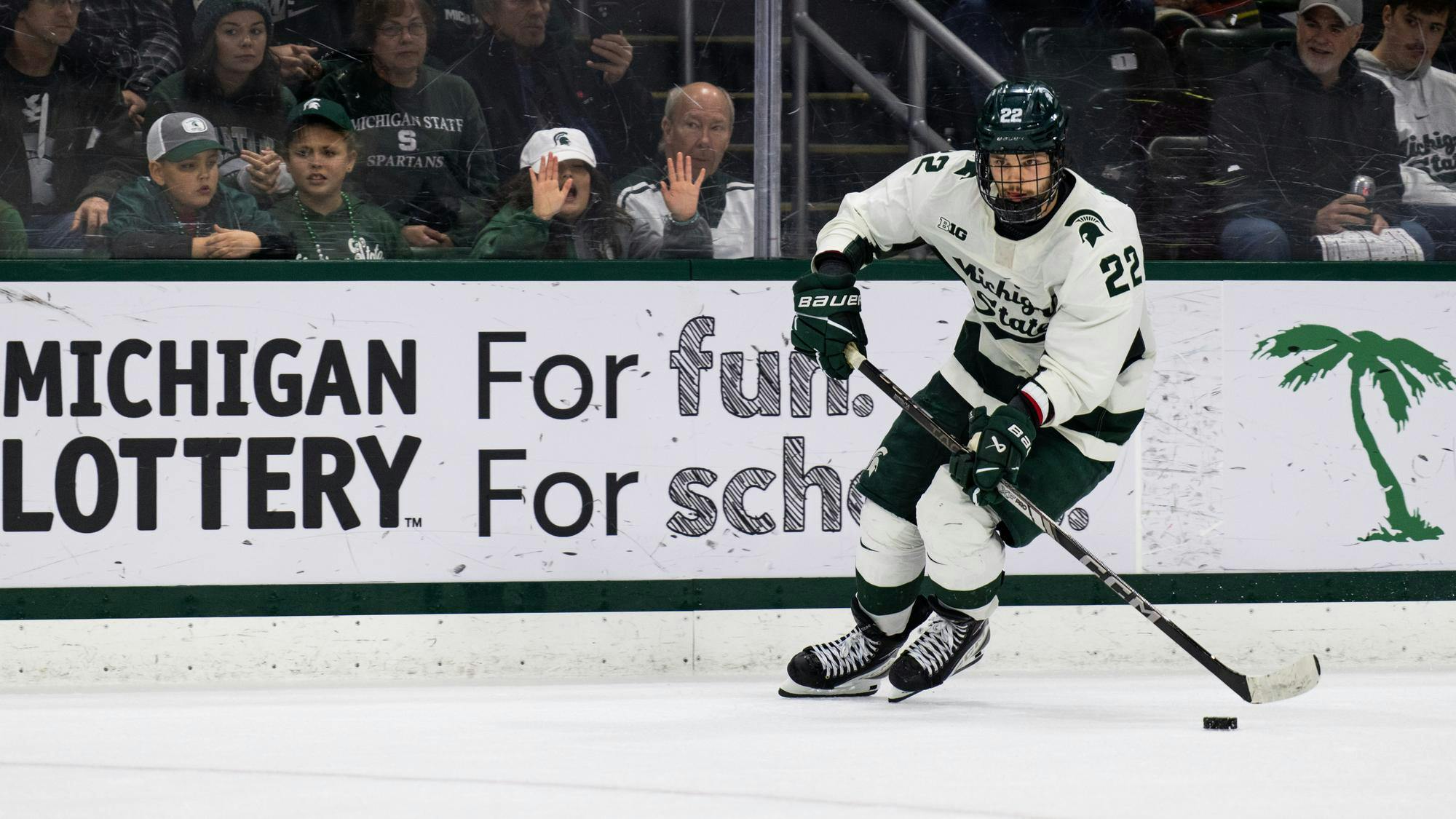 Michigan State junior forward Isaac Howard (22) skates in with the puck during the shootout at Munn Ice Arena on Jan. 25, 2025. The Spartans completed the season sweep of the Golden Gophers following a 4-3 shoot out victory.