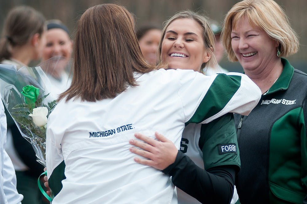<p>Senior outfielder Dana Briggs hugs head coach Jacquie Joseph before the game against Nebraska on April 27, 2014, at Secchia Stadium at Old College Field. The seniors were honored before the game. Julia Nagy/The State News</p>