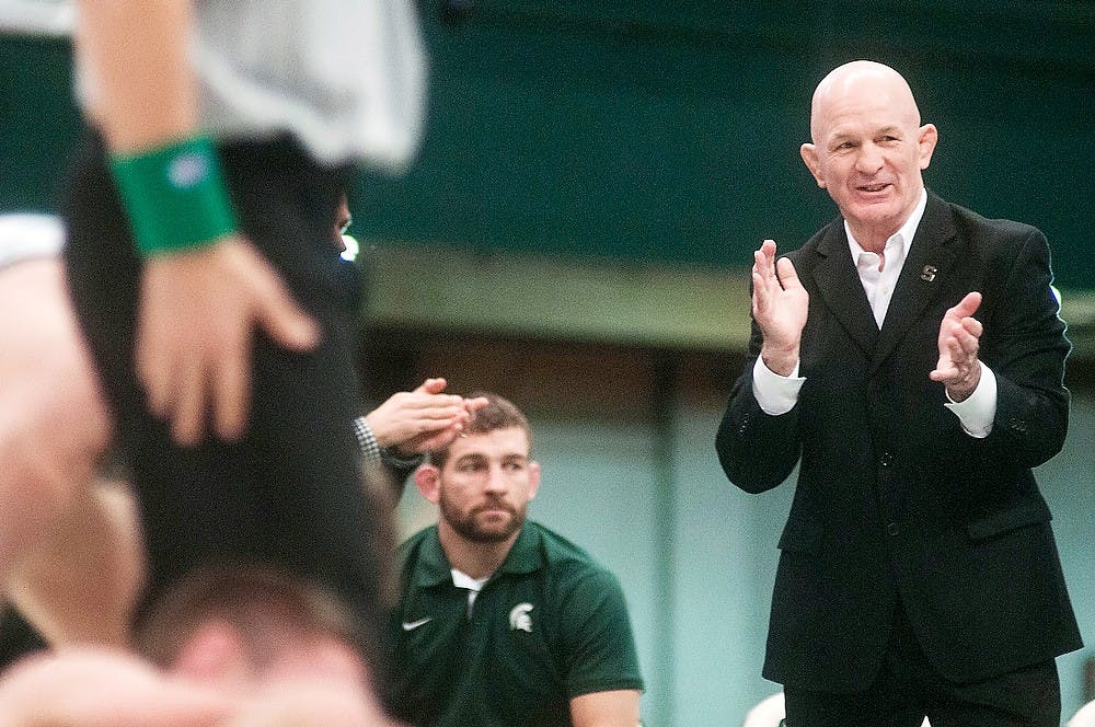 	<p>Wrestling head coach Tom Minkel cheers on junior 125-pounder Brenan Lyon after Lyon won his match against Michigan 125-pounder Sean Boyle on Sunday, Feb. 10, 2013, at Jenison Field House. <span class="caps">MSU</span> lost the meet against the University of Michigan 24-15. Danyelle Morrow/The State News</p>