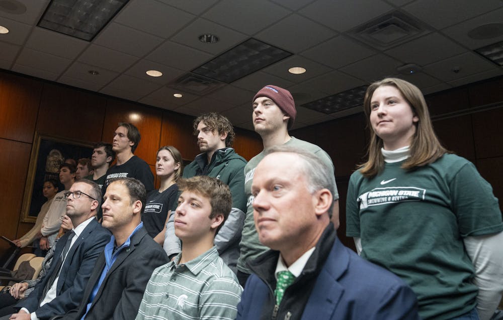 <p>Members of the swim and dive team stand during the Board of Trustees meeting on Friday, Dec. 16, 2022 at the Hannah Administration Building.&nbsp;</p>