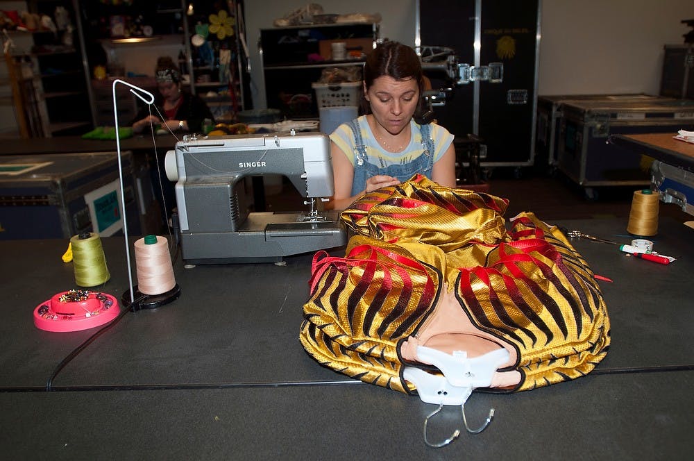 <p>Cirque employee Nathelie Martin tailors costumes for the Cirque Du Soleil "Varekai" on April 2, 2014, at the Breslin Center. The wardrobe team works to clean and adjust costumes before every "Varekai" performance. Allison Brooks/The State News</p>