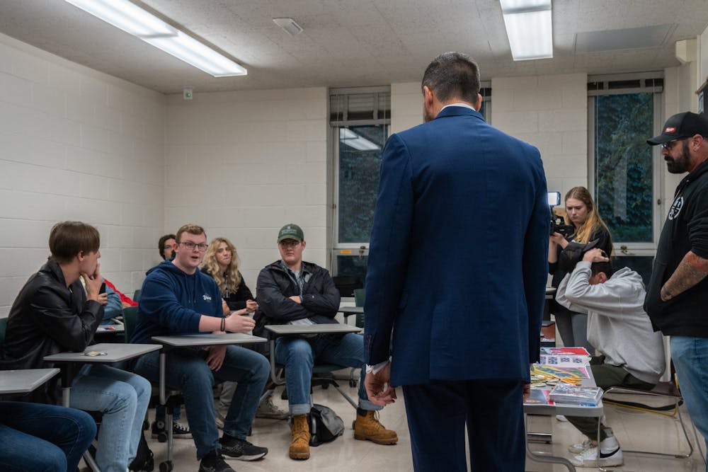 Former Republican gubernatorial candidate Ryan Kelley and comparative cultures and politics sophomore Jesse Estrada-White talk at a Turning Point MSU meeting in Wells Hall on Sept. 26, 2022.