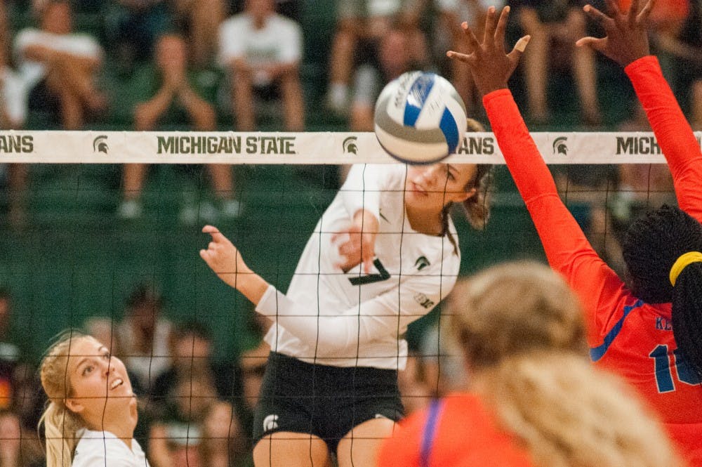 Junior middle blocker Alyssa Garvelink (17) hits the volleyball during the volleyball game against the University of Florida on Sept. 4, 2016 at Jenison Field House. The Spartans were defeated by the Gators, 3-0.