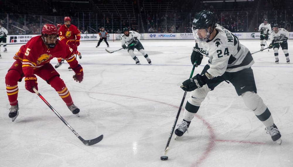 <p>Junior left wing Erik Middendorf (24) prepares to take a shot at the Ferris State goal in the first period. The Spartans beat the Bulldogs, 2-0, in the final minutes of the game on Nov. 11, 2021. </p>