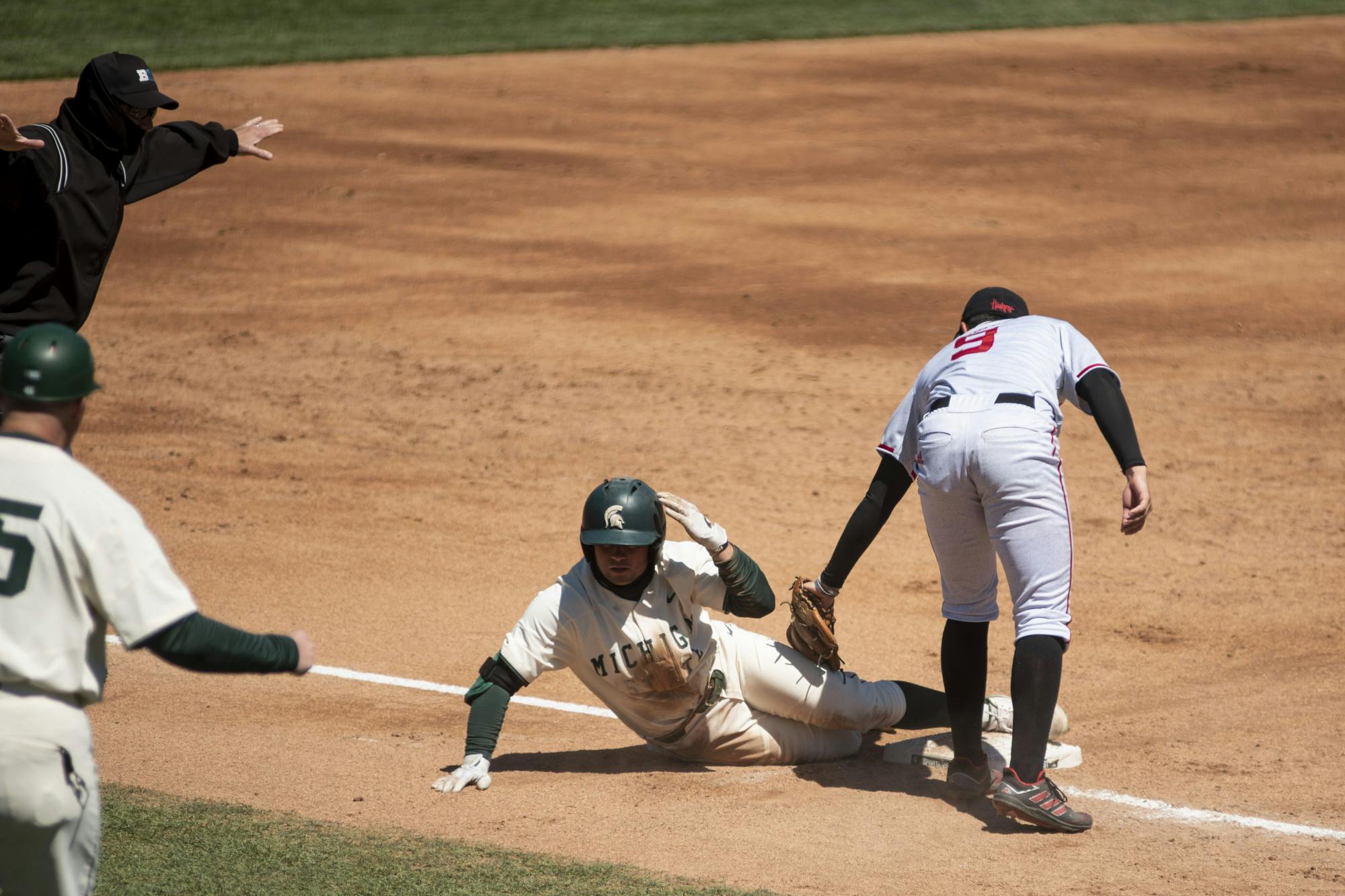 Freshman infielder Trent Farquhar (1) safe after sliding into third base during the game against Nebraska on April 25, 2021, at the McLane Stadium. The Cornhuskers defeated the Spartans 9-6.