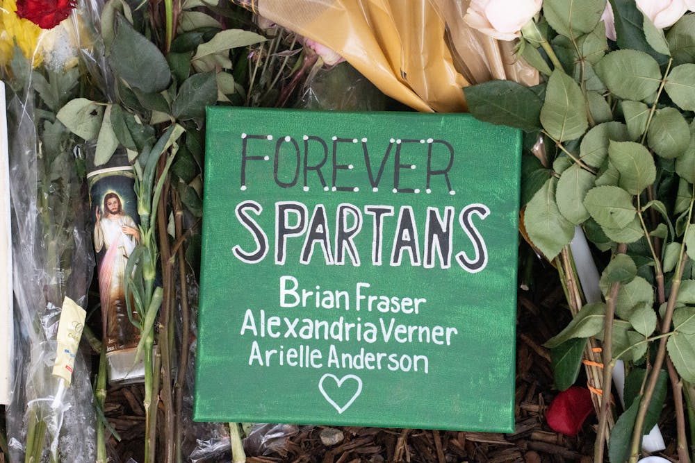 <p>MSU students, faculty, and staff gather to help clean up the memorial sites at the Rock, Spartan Statue, the MSU Union and Berkey Hall on Mar. 2, 2023</p>