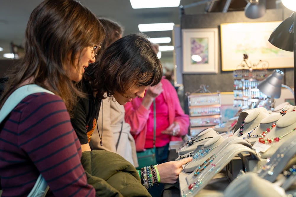 Shoppers take a look at the necklaces on sale at the 60th annual Arts and Crafts Show on Dec. 2, 2023.  The University Activities Board (UAB) hosts this event annually at the MSU Union.