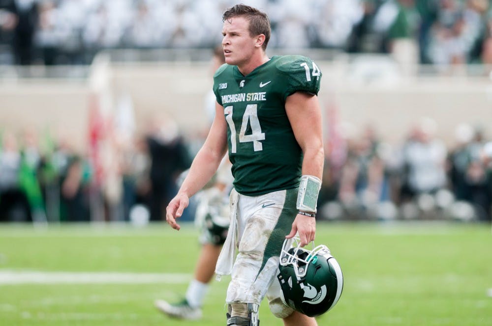 <p>Quarterback Brian Lewerke (14) walks off the field after the game against Northwestern on Oct. 6, 2018 at Spartan Stadium. </p>