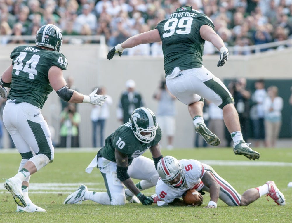 	<p>Ohio State quarterback Braxton Miller is tackled by senior linebacker Chris Norman during a game on Saturday, Sept. 29, 2012 at Spartan Stadium. The Spartans lost against the Buckeyes 17-16. Julia Nagy/The State News</p>