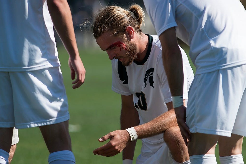 	<p>Junior defender Ryan Keener tends to his injury during the game against Northern Illinois on Sept. 28, 2013, at DeMartin Stadium at Old College Field. The Spartans defeated the Huskies, 2-0. Julia Nagy/The State News</p>