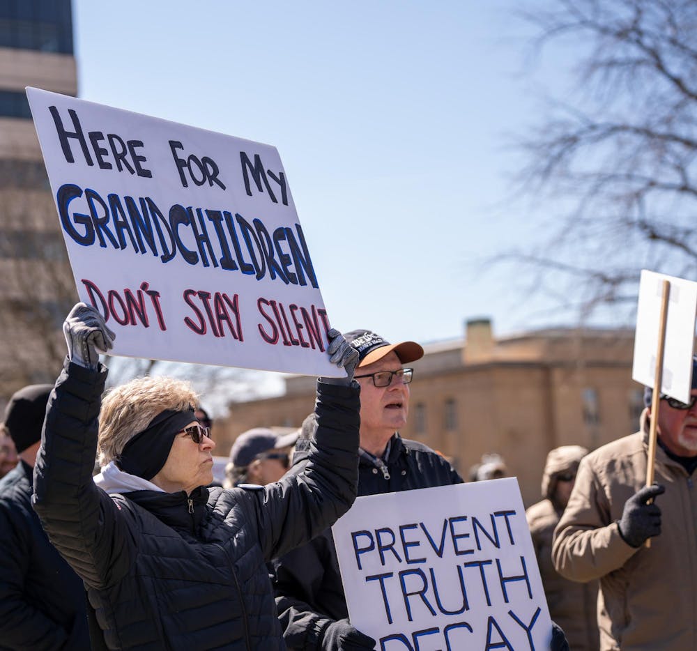 <p>Protestors hold up their signs during the No Kings Protest at the Michigan State Capitol in Lansing, MI on March 28, 2026.</p>
