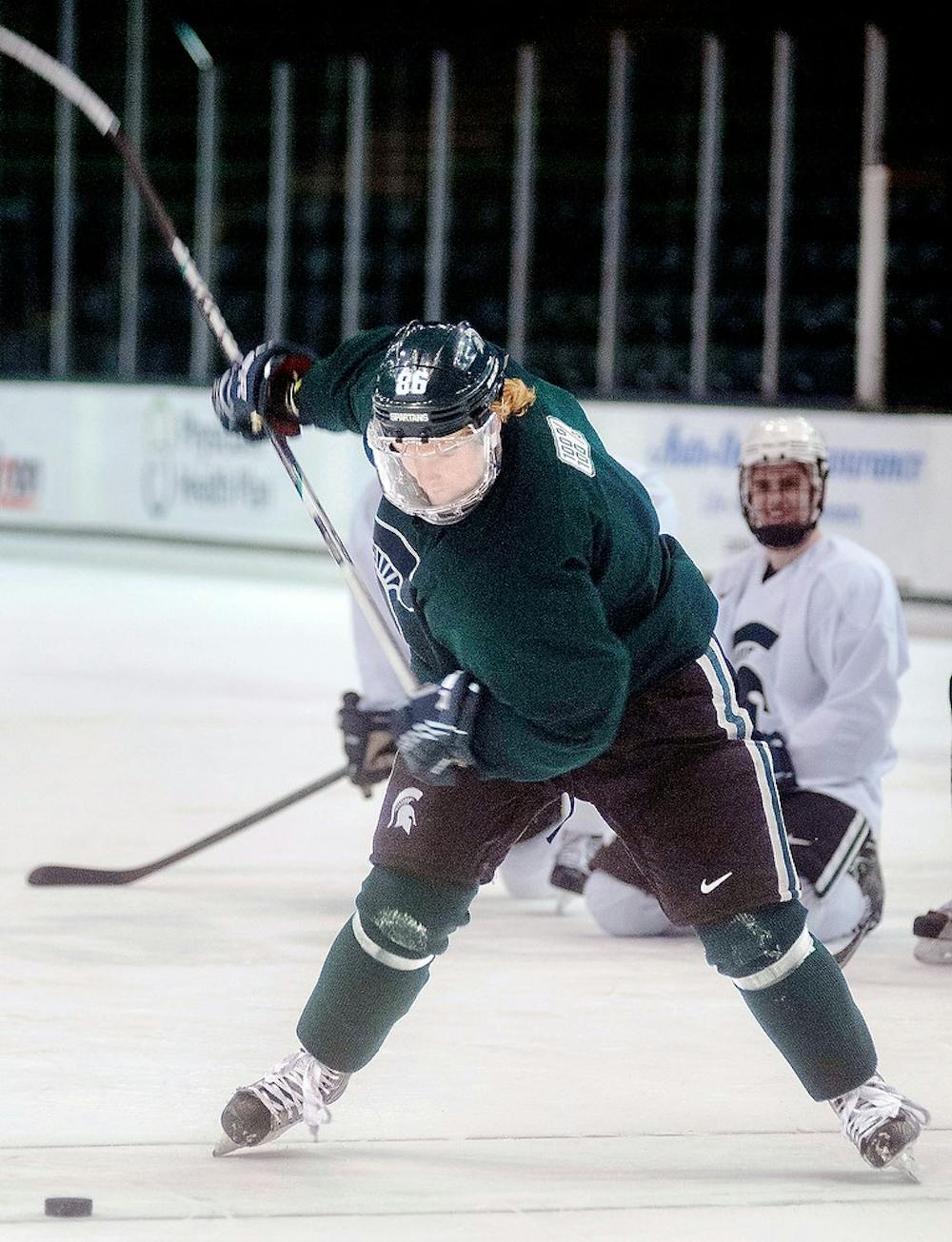 	<p>Junior forward Greg Wolfe prepares to take a slap shot during a skills competition portion of hockey practice Monday, Feb. 11, 2013, at Munn Ice Arena. During the hardest shot portion of the friendly competition Wolfe&#8217;s fastest shot was 97 miles per hour. Danyelle Morrow/The State News</p>