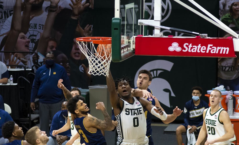 <p>Junior forward Aaron Henry (0) scores against Notre Dame in the first half of the game. Michigan State triumphed over Notre Dame, 80-70, on Nov. 28, 2020. </p>