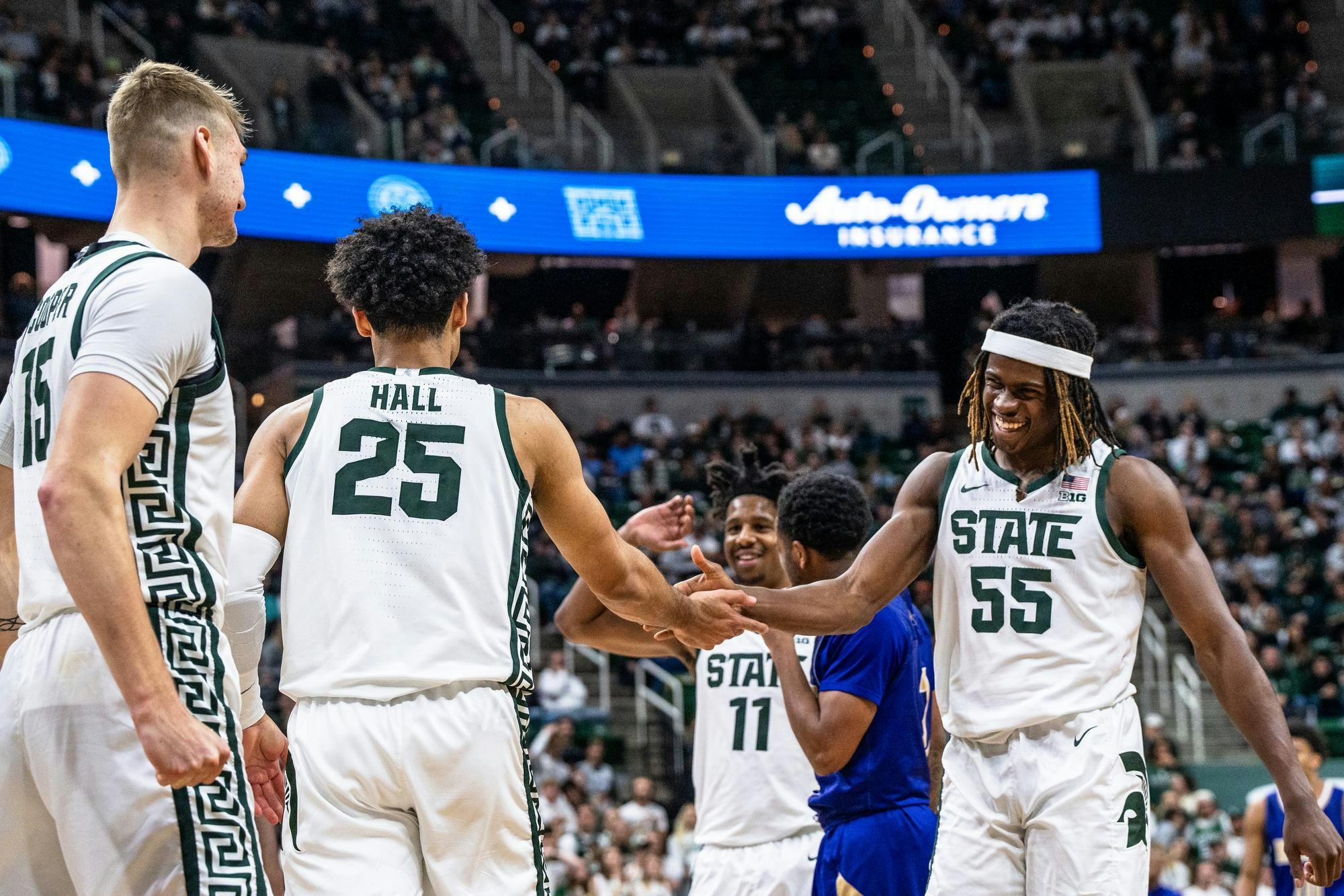 <p>Michigan State University freshman forward Coen Carr (55) high-fiving his teammates after an impressive play against Alcorn State University at the Breslin Center on Nov. 19, 2023. </p>