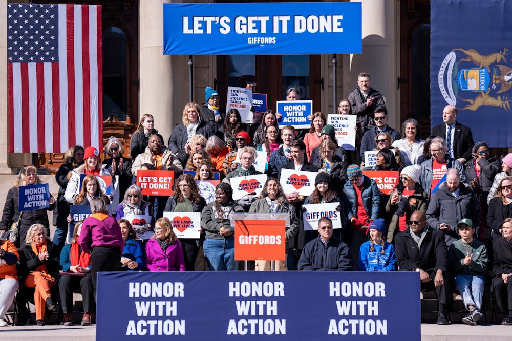 <p>Supporters stand together against gun violence as psychology junior Maya Manuel speaks at the Gabby Giffords gun rally at the Michigan State Capitol on March 15, 2023.</p>