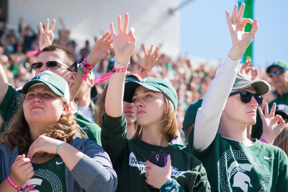 Students hold up three fingers in remembrance of Mike Sadler during the game against Wisconsin on Sept. 24, 2016 at Spartan Stadium.  The Spartans were defeated by the Badgers, 30-6.  