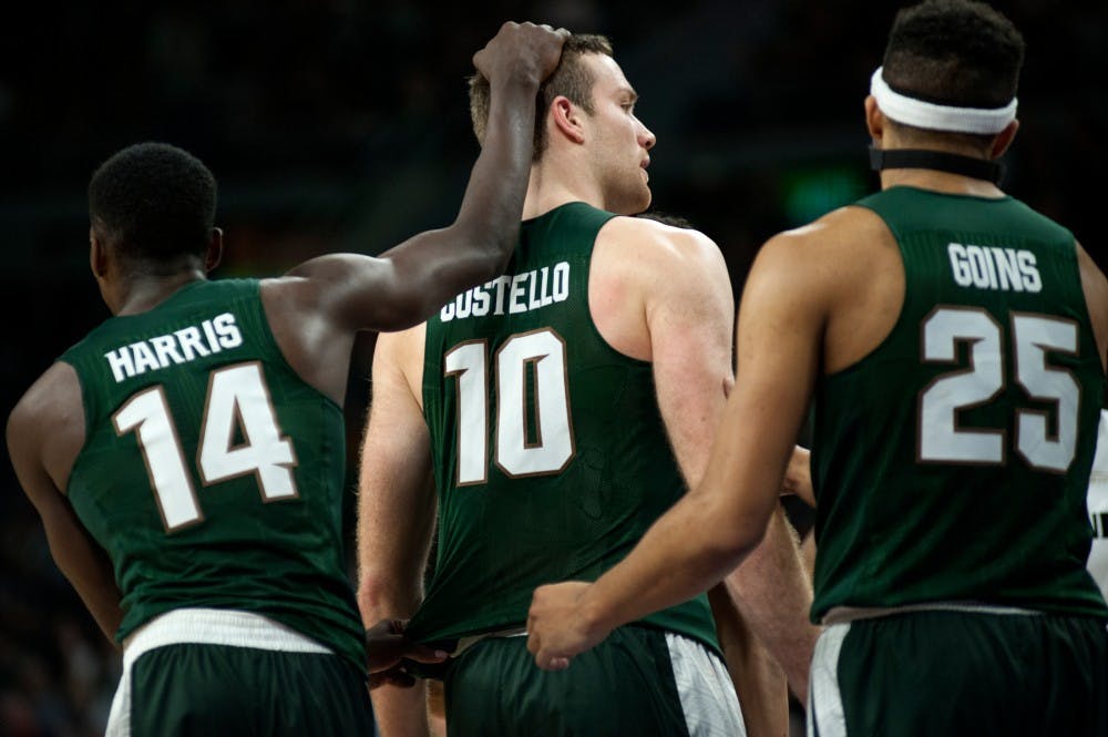 From left to right, junior guard Eron Harris, senior forward Matt Costello, and red shirt freshman Kenny Goins celebrate after scoring on Dec. 22, 2015 during the game against Oakland University at the Palace of Auburn Hillin Auburn Hills, Mich. The Spartans defeated the Grizzlies, 99-93 in overtime.