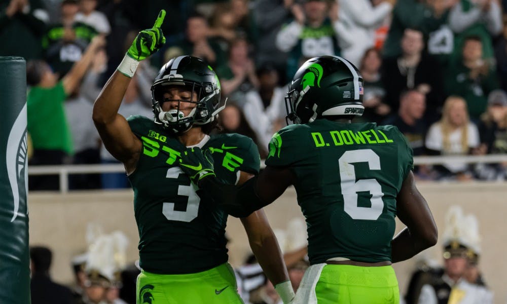 <p>Senior safety David Dowell (6) and sophomore safety Xavier Henderson (3) celebrate a stop against Western Michigan. The Spartans defeated the Broncos, 51-17, at Spartan Stadium on Sept. 7, 2019. </p>