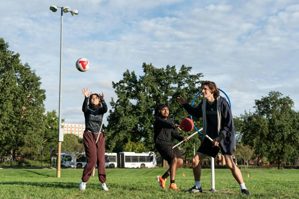 <p>Michigan State quadball freshman keeper Heavenlily Angeline Trelease catches the quadball as senior beater Adwai Bogolu attempts to knock out senior chaser Owen Connell during their practice at IM East Field in East Lansing, Mich., on Monday, Sept. 21, 2026.</p>