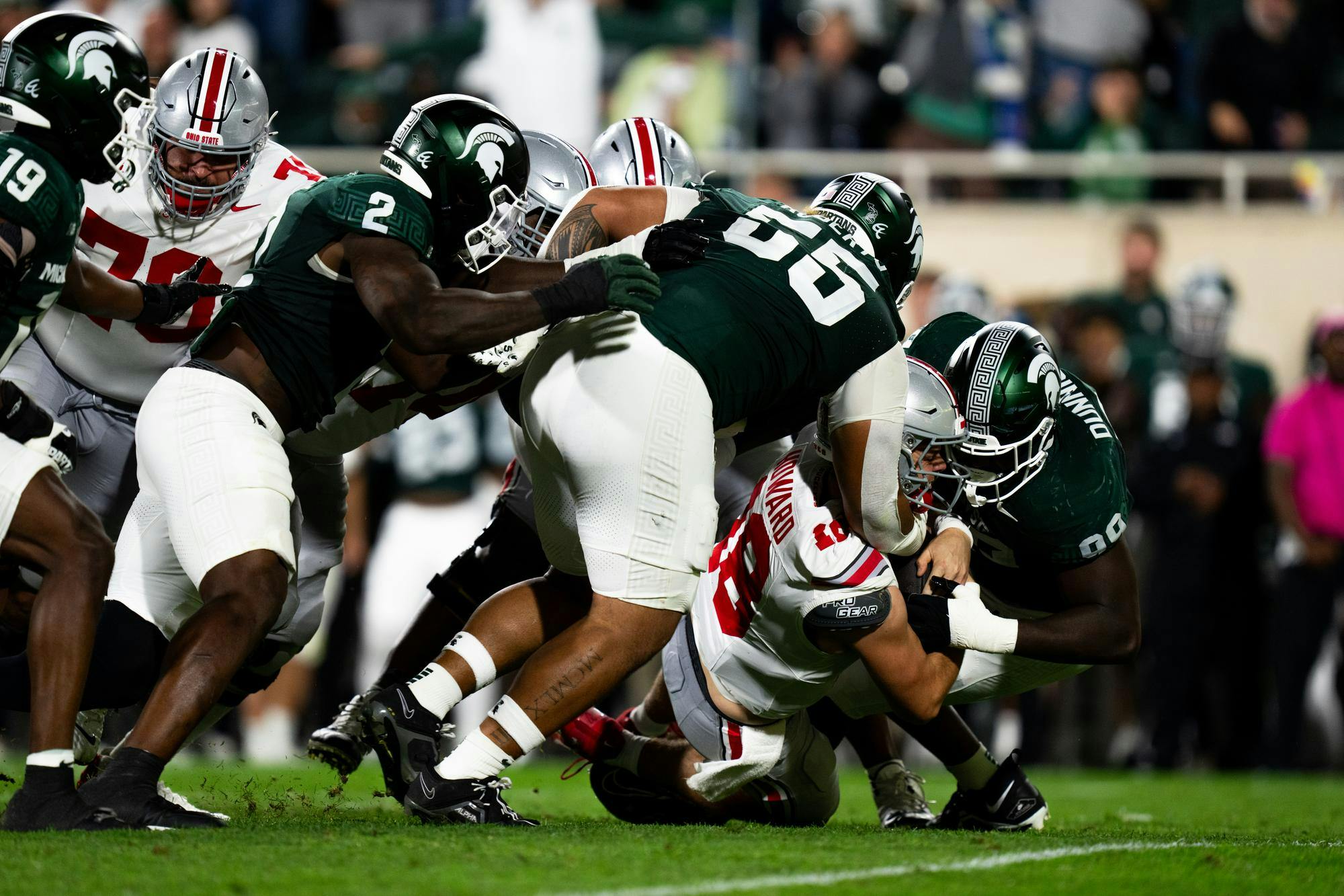 <p>Ohio State graduate quarterback Will Howard (18) is tackled by the Michigan State defense at the game against the Ohio State Buckeyes held in the Spartan Stadium on Sept. 29, 2024. Despite a competitive first half, the Spartans fell 38-7 to the Buckeyes.</p>