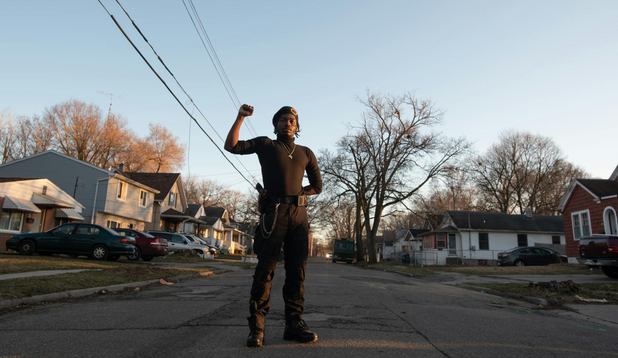 <p>James Henson stands with his right fist raised on Bensch Street in the predominantly Black neighborhood that he grew up in on March 11, 2021.</p>