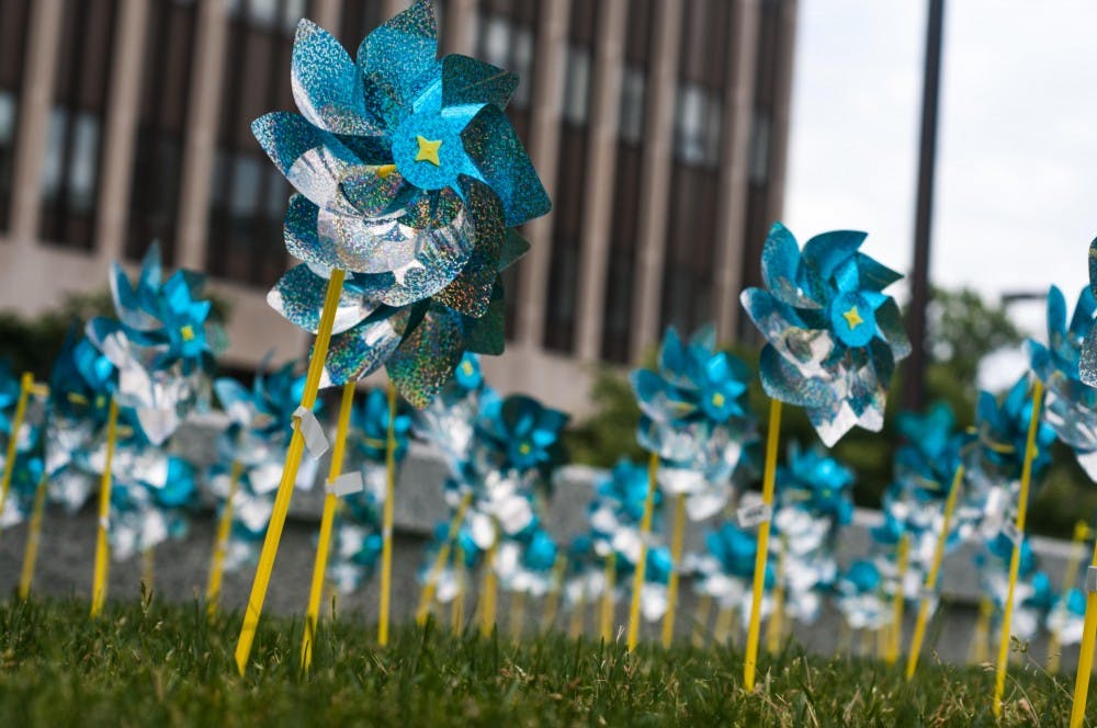 <p>Approximately 300 pinwheels sit outside the Hannah Administration Building to represent all the survivors of Larry Nassar on June 22, 2018.</p>