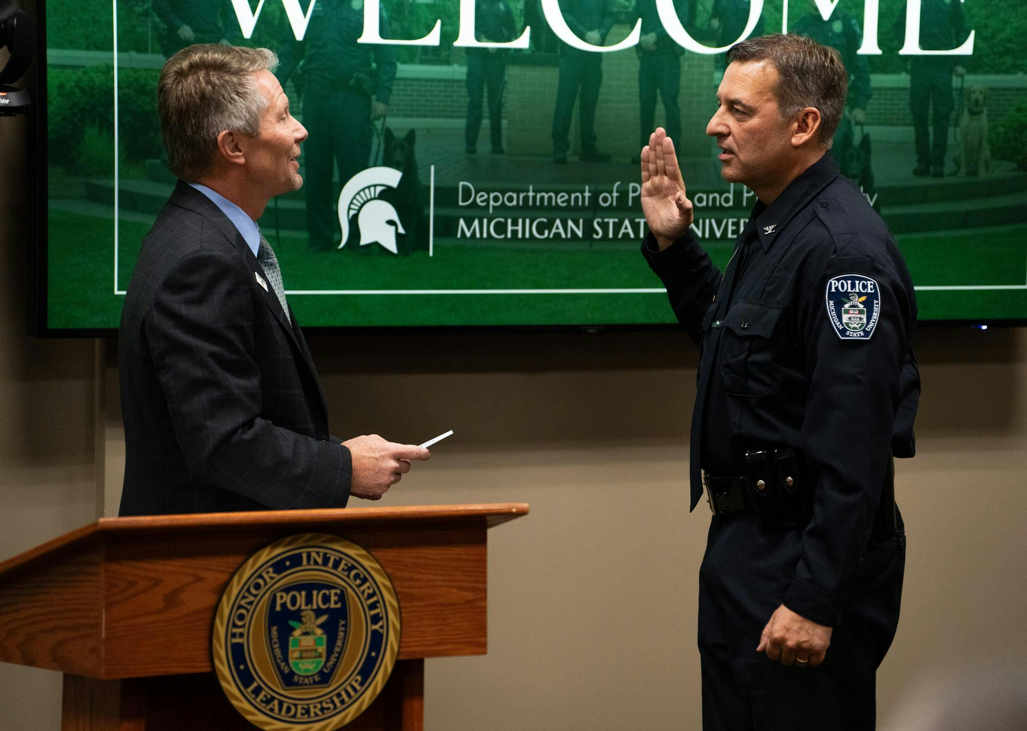 <p>Michigan State University President Kevin M. Guskiewicz administers the oath of office to Mike Yankowski, the university's new police chief and executive director of public safety, at the Michigan State University Police Department on Nov. 14, 2024.</p>